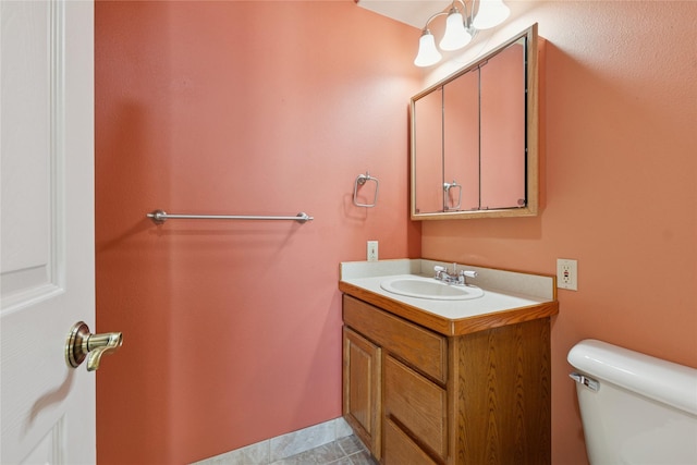 half bathroom with toilet and vanity