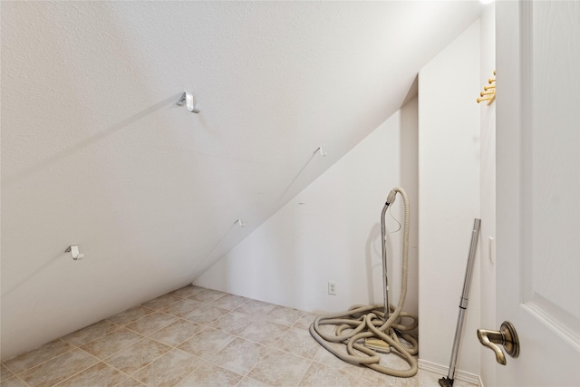 additional living space featuring vaulted ceiling