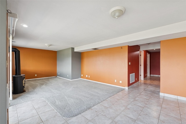 empty room featuring visible vents, baseboards, recessed lighting, light colored carpet, and light tile patterned floors