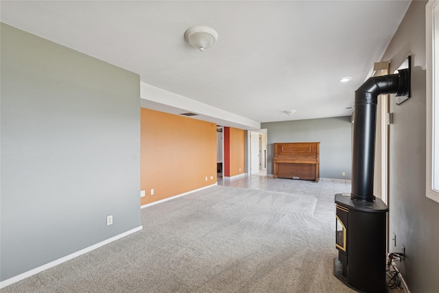 unfurnished living room with baseboards, light carpet, and visible vents