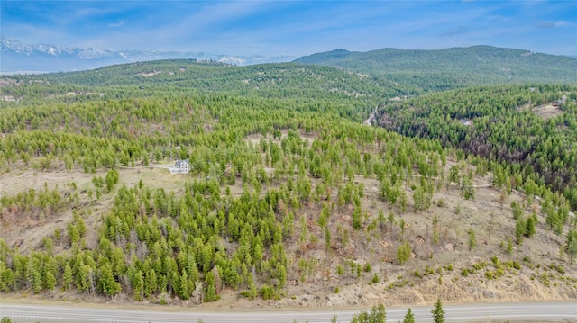 birds eye view of property with a mountain view and a forest view