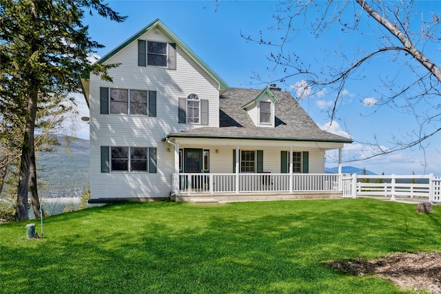 view of front of house featuring a front lawn, fence, a chimney, a shingled roof, and a porch