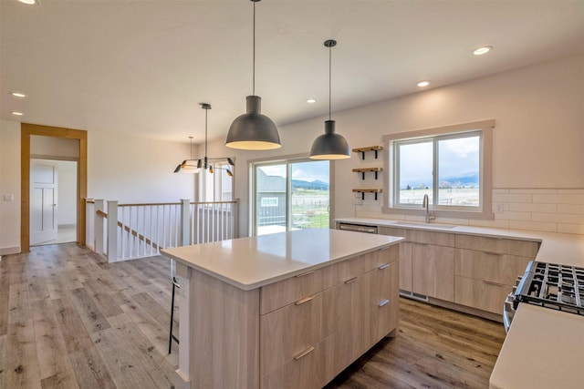 5498 Thimbleberry Loop, Helena, MT 59602 - kitchen with a kitchen island, modern cabinets, a sink, light wood finished floors, and light brown cabinets