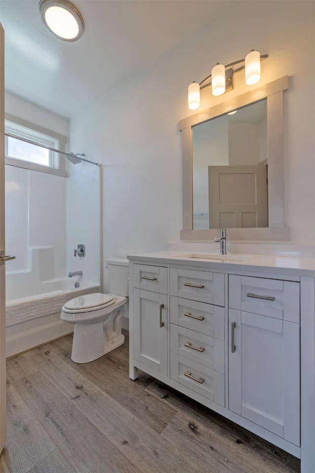 5498 Thimbleberry Loop, Helena, MT 59602 - bathroom featuring vanity, bathing tub / shower combination, toilet, and wood finished floors