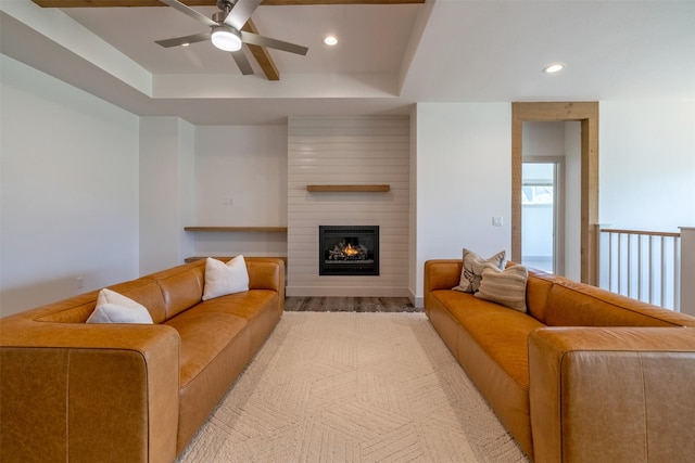 5498 Thimbleberry Loop, Helena, MT 59602 - living area featuring a large fireplace, a ceiling fan, recessed lighting, light wood-type flooring, and a tray ceiling
