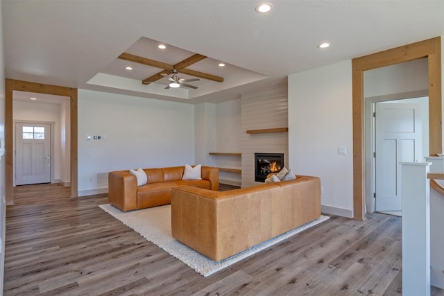 5498 Thimbleberry Loop, Helena, MT 59602 - living room with light wood-style floors, baseboards, a fireplace, and a ceiling fan