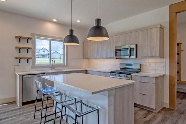 5498 Thimbleberry Loop, Helena, MT 59602 - kitchen with a sink, appliances with stainless steel finishes, modern cabinets, and light brown cabinets