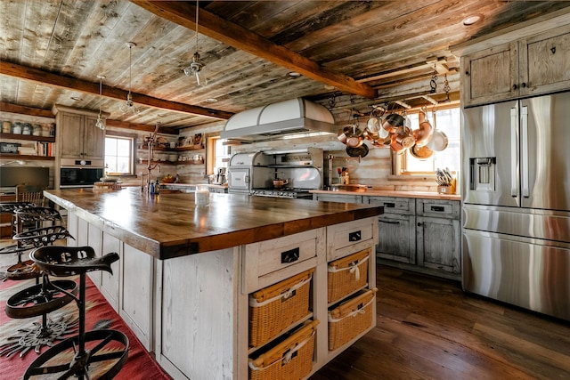 kitchen featuring wood ceiling, wooden counters, dark wood-style flooring, appliances with stainless steel finishes, and extractor fan