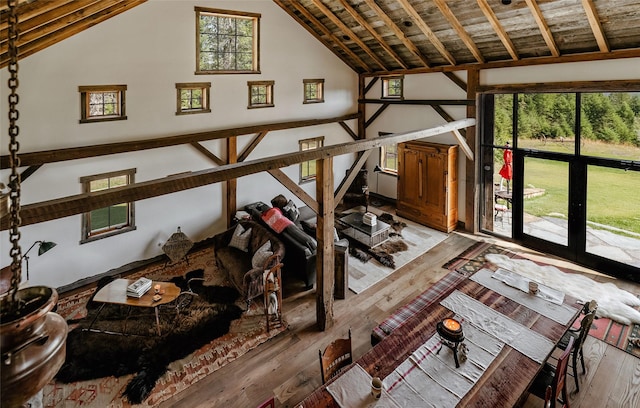 interior space featuring light wood-style flooring and high vaulted ceiling