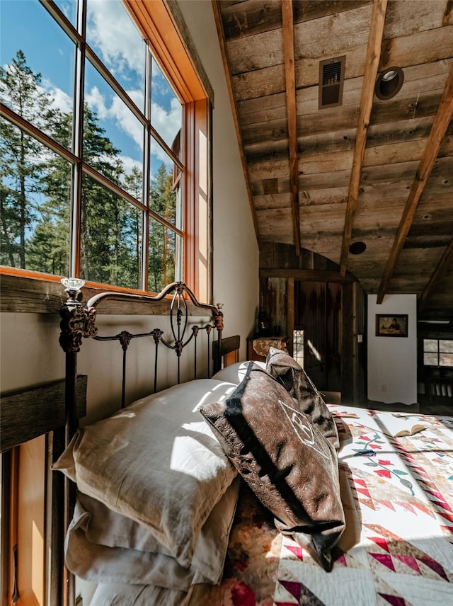 bedroom with vaulted ceiling with beams, wood ceiling, visible vents, and multiple windows
