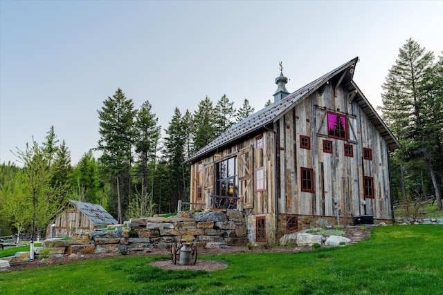 exterior space with an outbuilding, a yard, and a barn