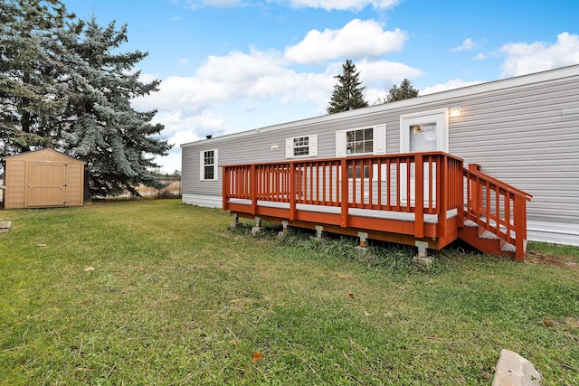 rear view of property featuring a storage shed, a lawn, an outbuilding, and a deck