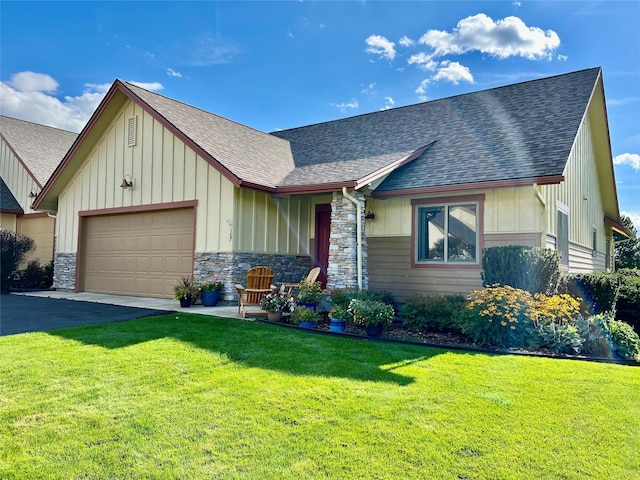 107 Crescent Lndg, Polson, MT 59860 - view of front facade with board and batten siding, a front yard, roof with shingles, and a garage
