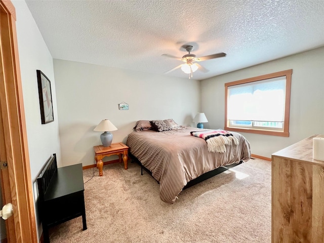 107 Crescent Lndg, Polson, MT 59860 - bedroom with a textured ceiling, ceiling fan, baseboards, and carpet