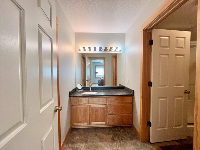 107 Crescent Lndg, Polson, MT 59860 - ensuite bathroom with baseboards, ensuite bathroom, vanity, and a textured ceiling