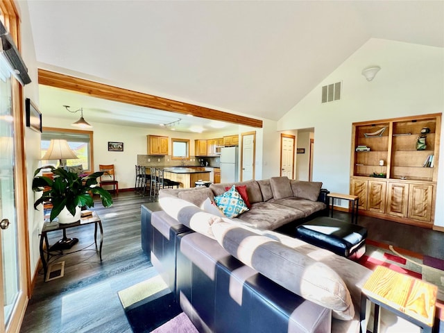 107 Crescent Lndg, Polson, MT 59860 - living room with visible vents, baseboards, dark wood-type flooring, and high vaulted ceiling