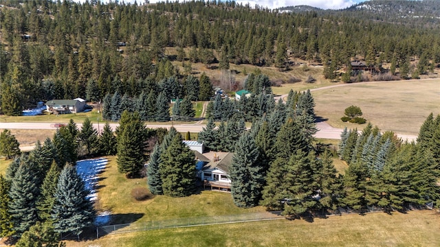 birds eye view of property featuring a view of trees