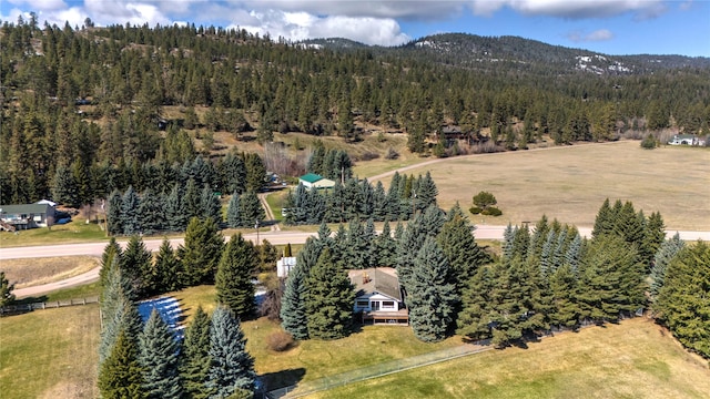 drone / aerial view with a forest view and a mountain view