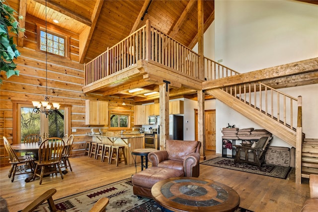 living room with wood-type flooring, high vaulted ceiling, and an inviting chandelier
