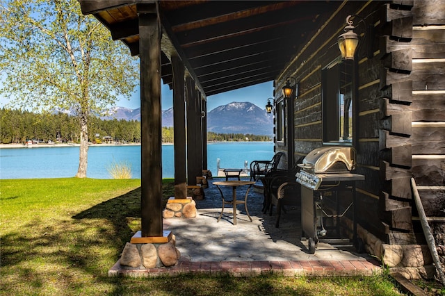 view of patio featuring a water and mountain view