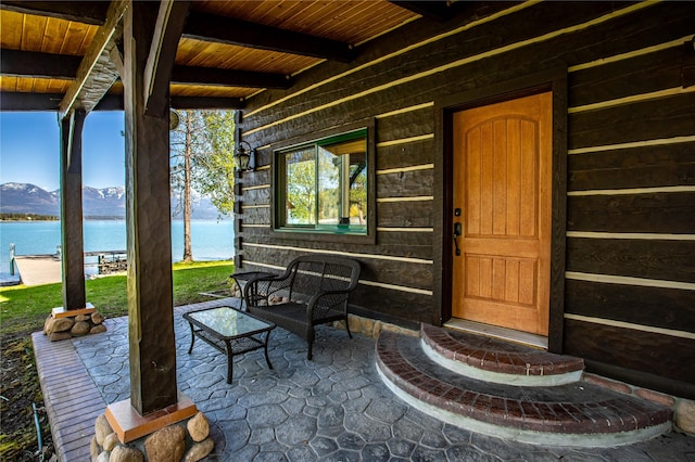 view of exterior entry featuring a water and mountain view