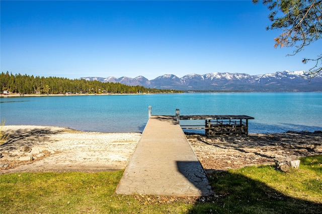 view of dock with a water and mountain view