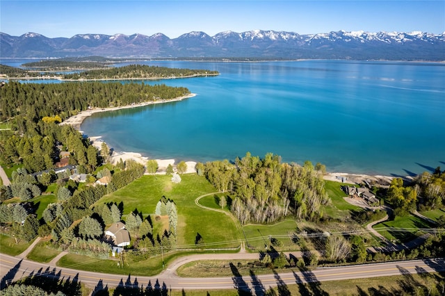 drone / aerial view featuring a water and mountain view
