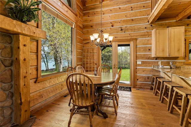 dining room featuring wood walls and light wood-style floors