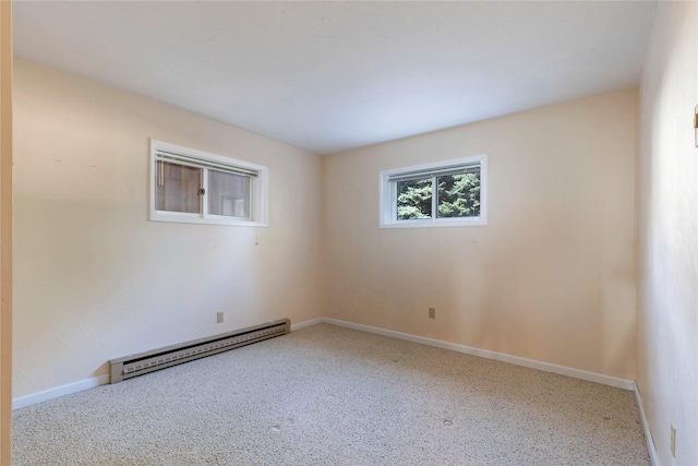 carpeted empty room with baseboards and a baseboard heating unit