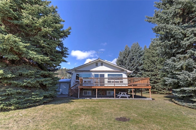 back of property with stairs, a yard, and a deck