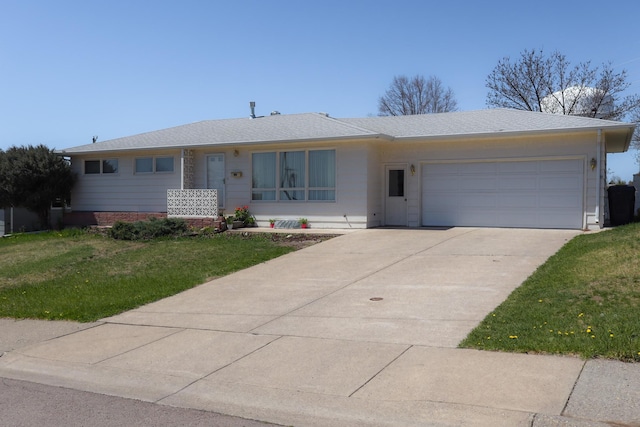 single story home featuring concrete driveway, a front yard, and a garage