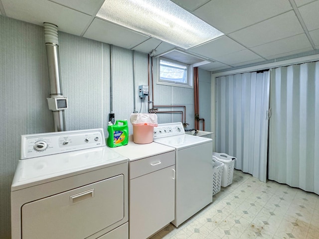 laundry room with washing machine and dryer and light floors
