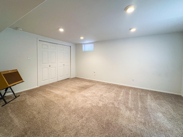 unfurnished bedroom featuring baseboards, carpet flooring, recessed lighting, and a closet