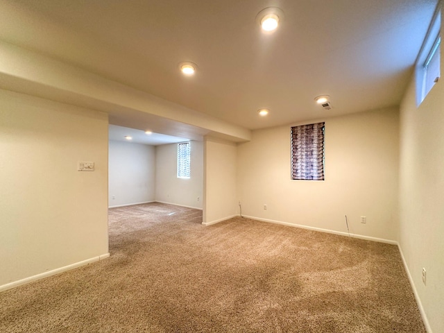 basement featuring baseboards, recessed lighting, and carpet