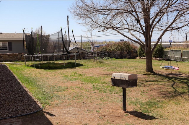 view of yard featuring a fenced backyard and a trampoline