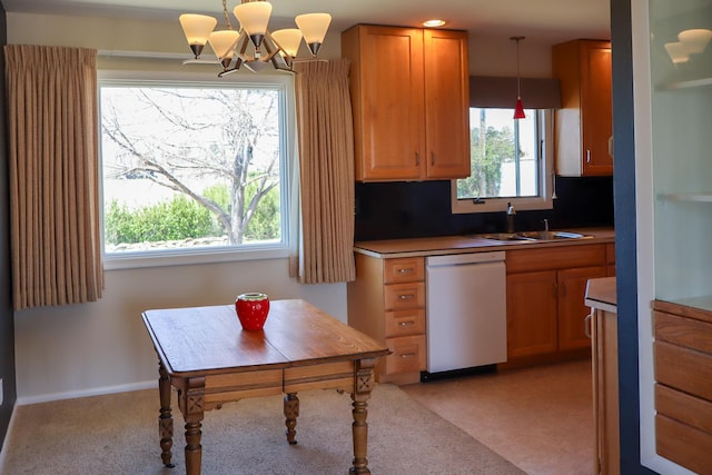 kitchen with brown cabinets, light carpet, a sink, dishwasher, and pendant lighting