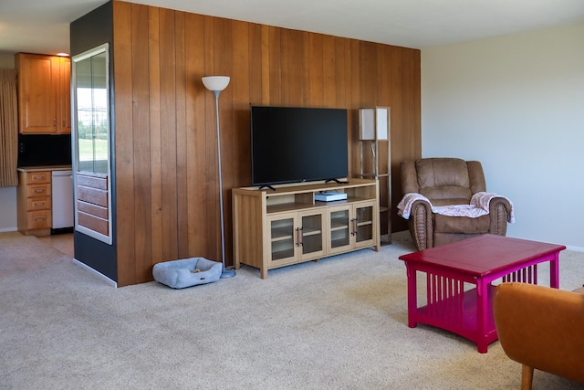 living area with wooden walls and carpet