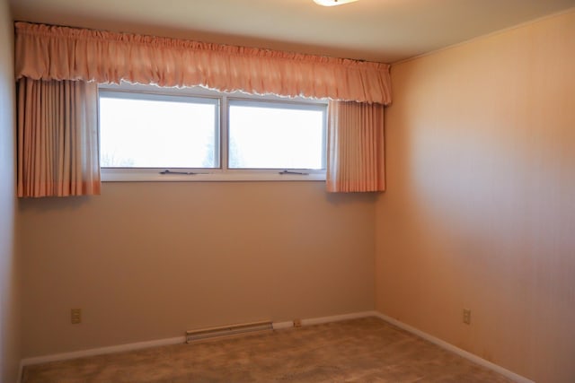 empty room featuring a healthy amount of sunlight, carpet flooring, and visible vents
