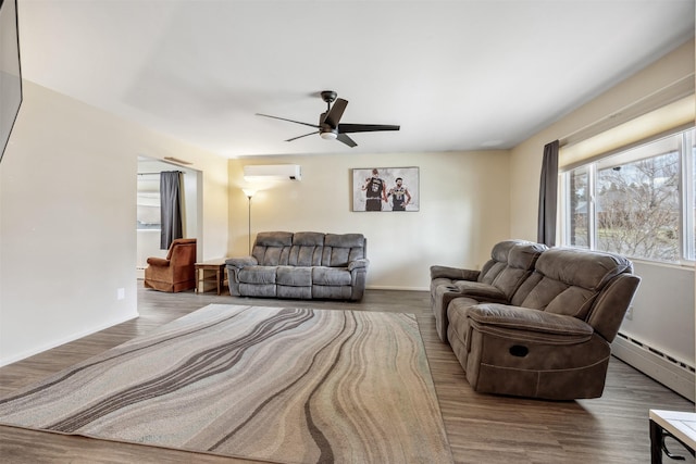 living room featuring ceiling fan, a wall unit AC, a baseboard heating unit, and wood finished floors