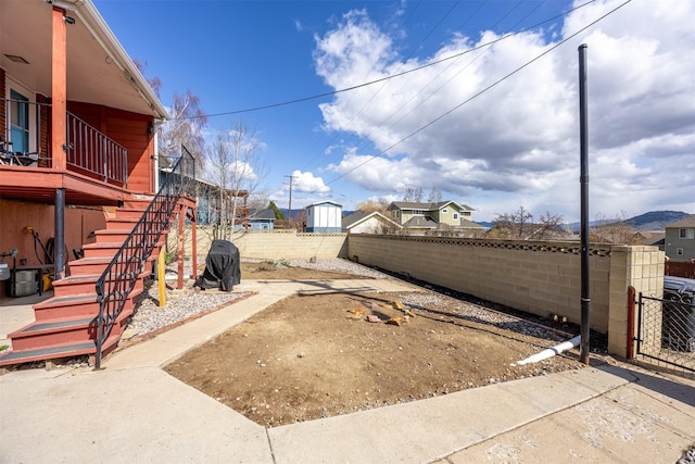 view of yard featuring stairway and fence