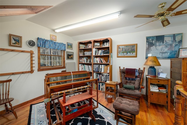 sitting room featuring baseboards, a ceiling fan, wood finished floors, and lofted ceiling