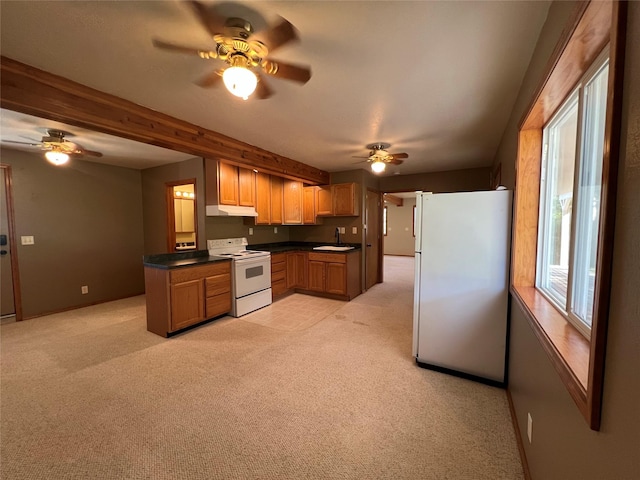 kitchen featuring a ceiling fan, dark countertops, under cabinet range hood, and white appliances