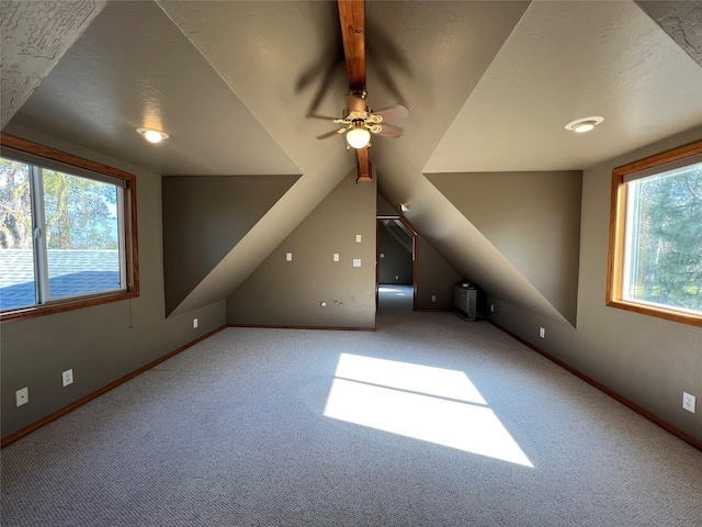 bonus room featuring plenty of natural light, carpet flooring, and lofted ceiling