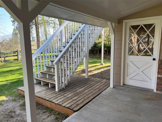 deck with a yard and fence