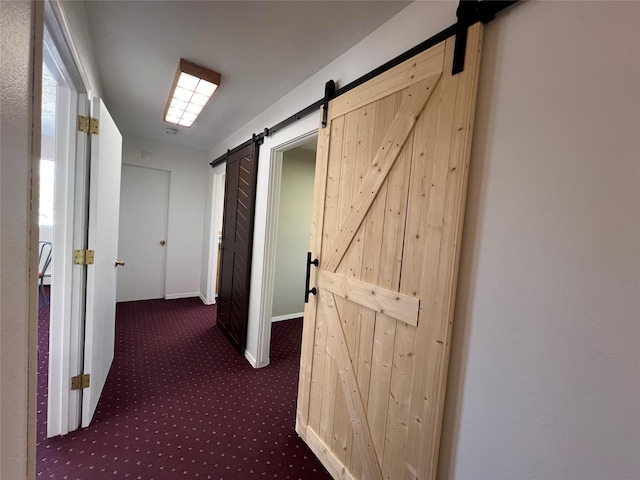 hall featuring carpet floors and a barn door
