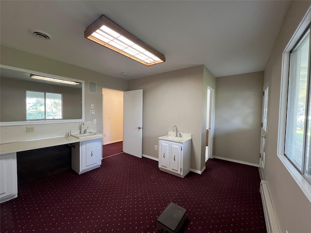 bathroom featuring vanity, baseboards, a baseboard heating unit, and visible vents