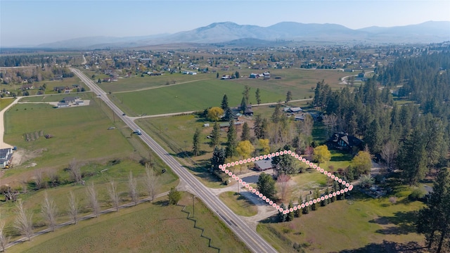 birds eye view of property featuring a mountain view and a rural view