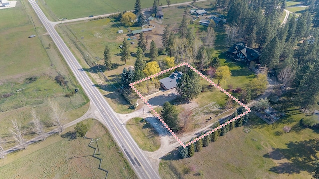birds eye view of property with a rural view