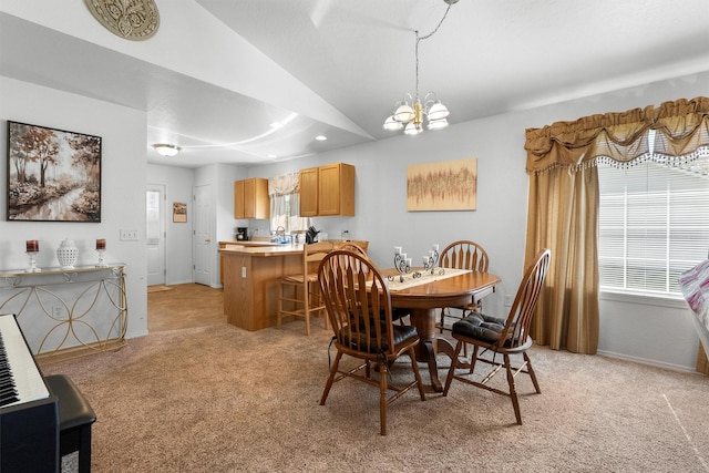 dining space featuring an inviting chandelier, a wealth of natural light, lofted ceiling, and light colored carpet