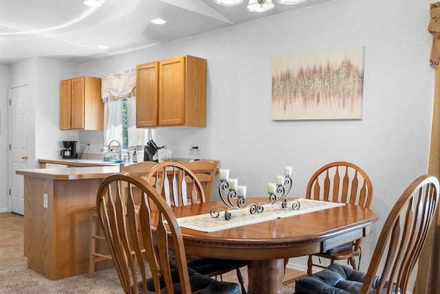 dining area featuring recessed lighting and light colored carpet